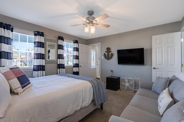 bedroom featuring carpet floors, multiple windows, and a ceiling fan