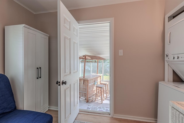 34 Holiday Rd, Villas, NJ 08251 - laundry area featuring estacked washer and dryer, light wood-type flooring, baseboards, and ornamental molding