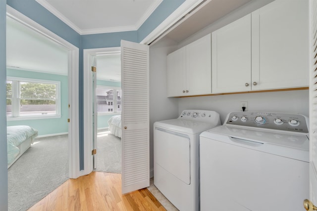 1520 Yacht Ave Unit 203, Cape May, NJ 08204 - laundry area featuring cabinet space, washing machine and clothes dryer, light wood finished floors, ornamental molding, and baseboards