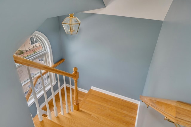 1520 Yacht Ave Unit 203, Cape May, NJ 08204 - staircase with a chandelier, healthy amount of natural light, wood finished floors, and baseboards
