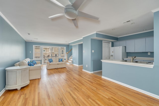 1520 Yacht Ave Unit 203, Cape May, NJ 08204 - living area featuring crown molding, a ceiling fan, stairway, light wood finished floors, and baseboards