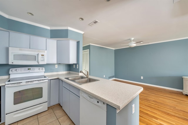 1520 Yacht Ave Unit 203, Cape May, NJ 08204 - kitchen with white appliances, a sink, a peninsula, ornamental molding, and a ceiling fan