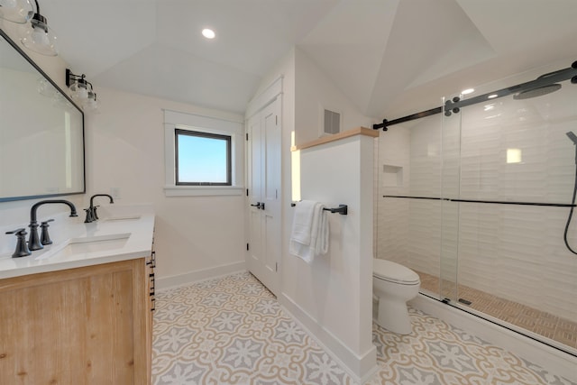 bathroom with lofted ceiling, vanity, tile patterned floors, toilet, and walk in shower