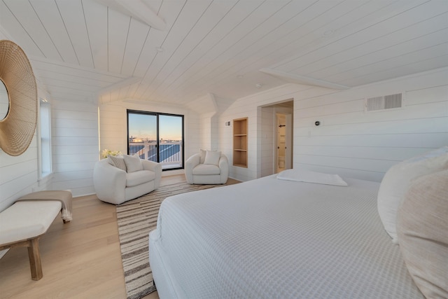 bedroom with wooden ceiling, access to exterior, wooden walls, and light hardwood / wood-style flooring