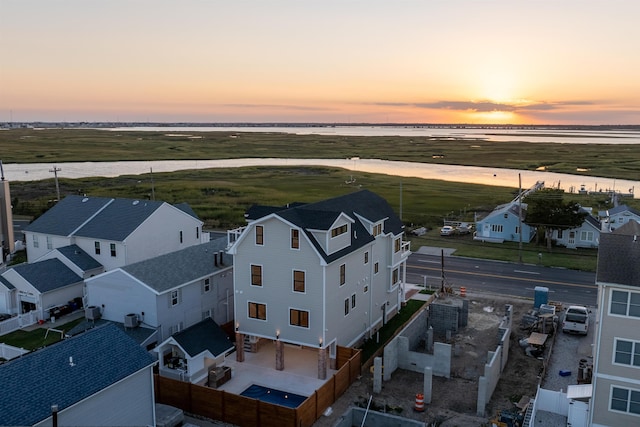 aerial view at dusk with a water view