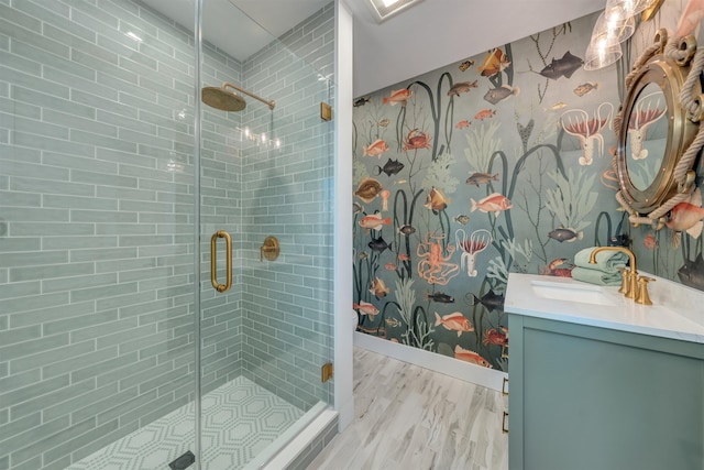 bathroom featuring vanity, a shower with shower door, and wood-type flooring