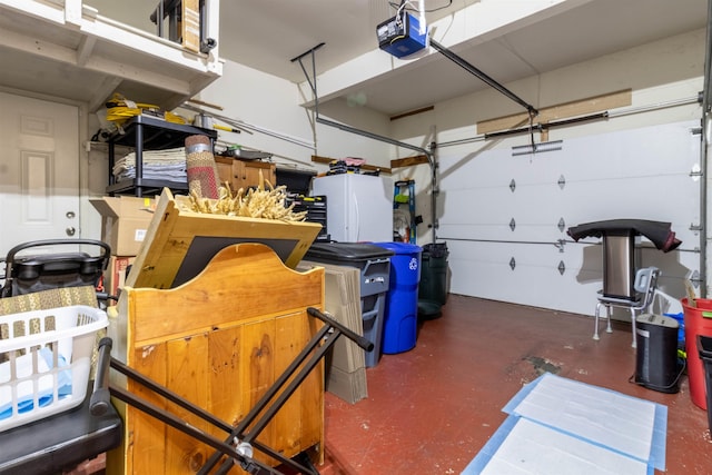 garage with a garage door opener and white refrigerator