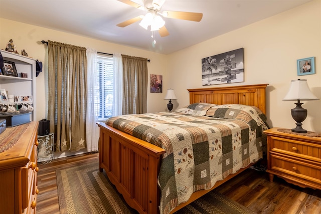 bedroom with ceiling fan and dark wood-type flooring