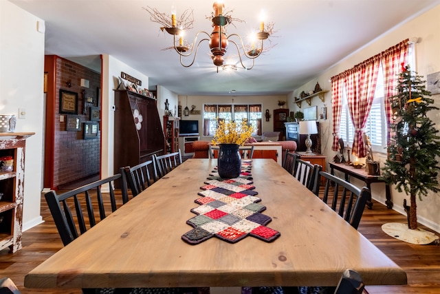 dining room with an inviting chandelier and dark wood-type flooring