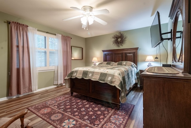 bedroom featuring ceiling fan and dark hardwood / wood-style flooring