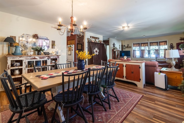 dining space with an inviting chandelier and hardwood / wood-style flooring