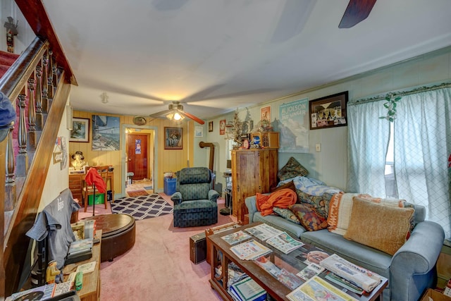 carpeted living room with stairway and a ceiling fan