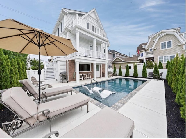 5765 Ocean Dr, Avalon, NJ 08202 - rear view of property featuring a balcony, a patio area, stairway, and brick siding