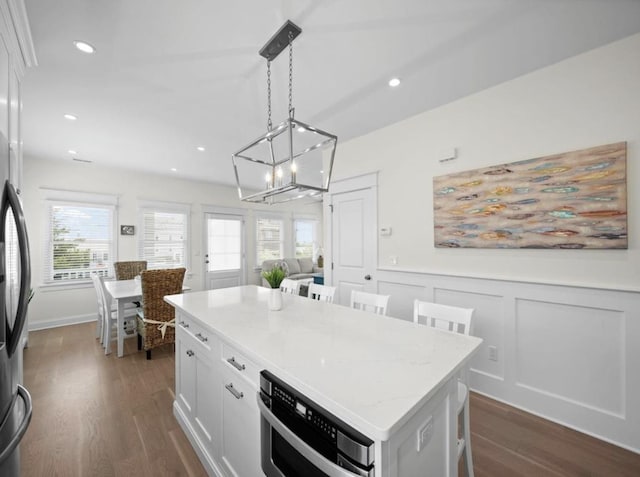 5765 Ocean Dr, Avalon, NJ 08202 - kitchen with a chandelier, dark wood-style floors, a wainscoted wall, a kitchen island, and white cabinetry