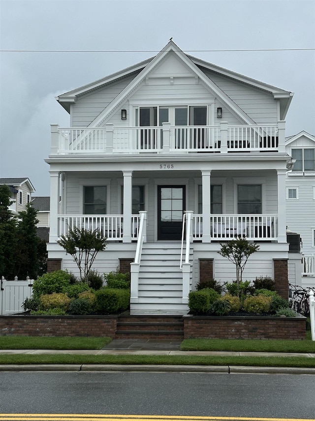 5765 Ocean Dr, Avalon, NJ 08202 - view of front facade featuring a balcony, a porch, and stairway