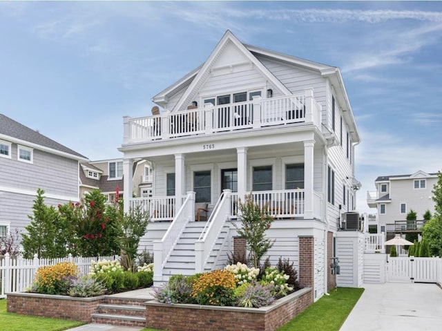 5765 Ocean Dr, Avalon, NJ 08202 - beach home with stairs, a gate, covered porch, central AC unit, and a balcony