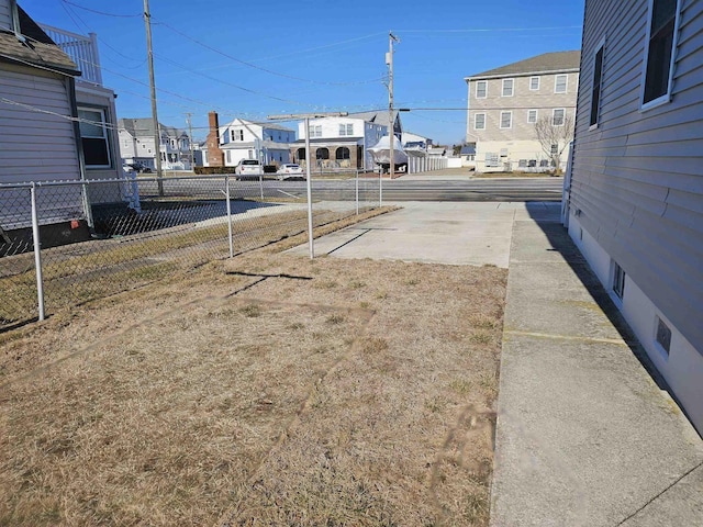 view of yard with a residential view and fence