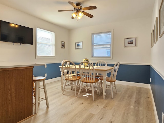 dining room with plenty of natural light, light wood-style flooring, and baseboards