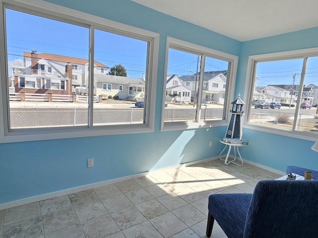 interior space with a residential view and baseboards