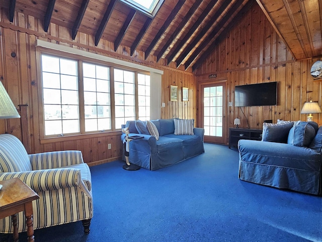 living area with carpet, lofted ceiling with beams, wooden ceiling, and wooden walls