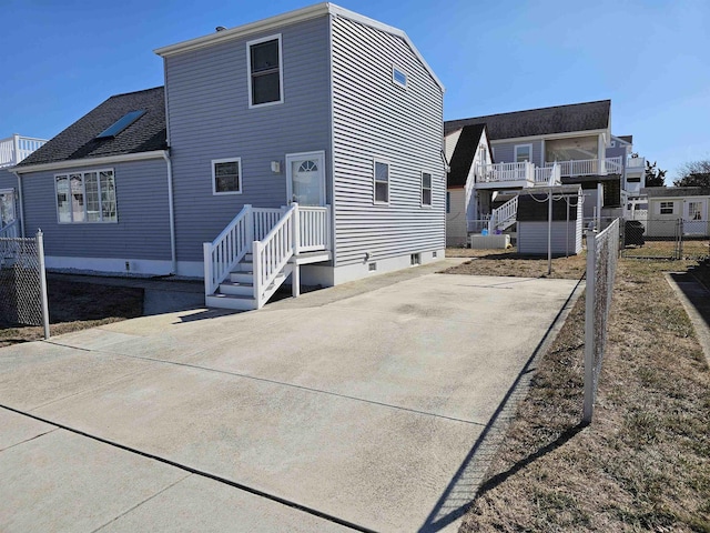 back of property featuring fence