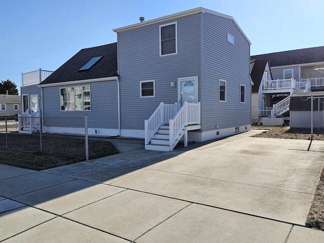 view of front of property featuring crawl space and a shingled roof