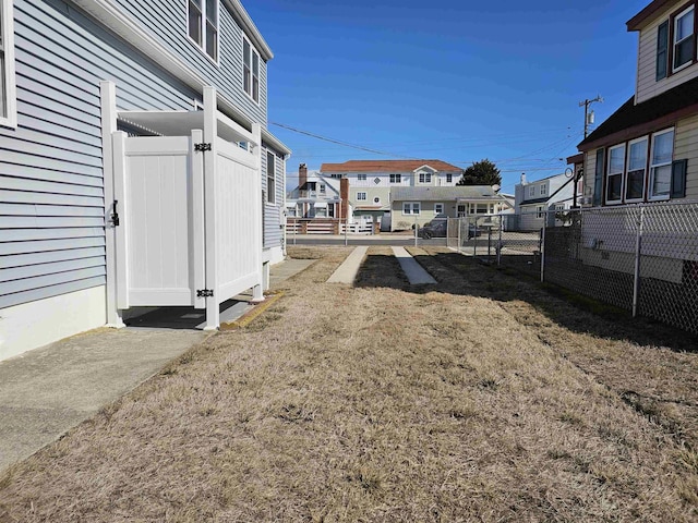 view of yard with fence and a residential view