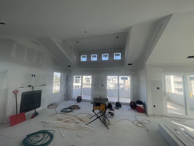 unfurnished living room featuring a towering ceiling