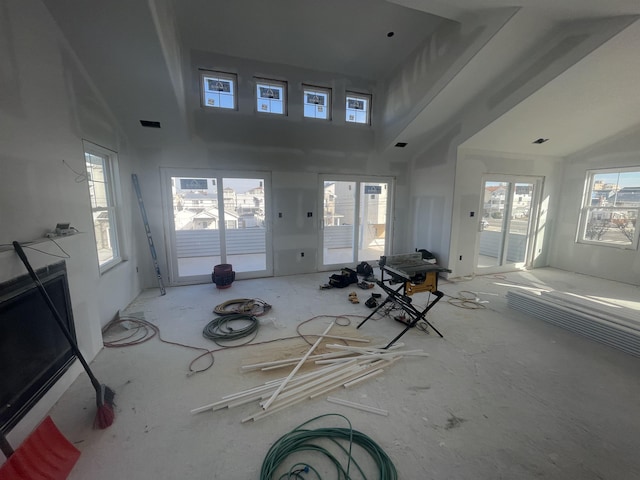 unfurnished living room featuring a high ceiling