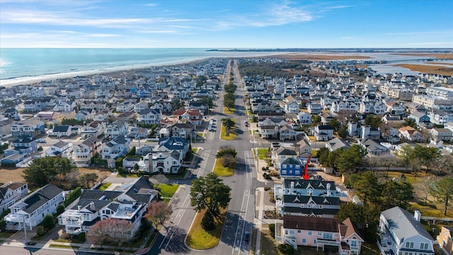 birds eye view of property with a water view and a view of the beach