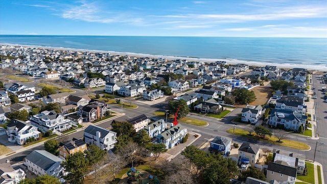 drone / aerial view with a water view and a view of the beach