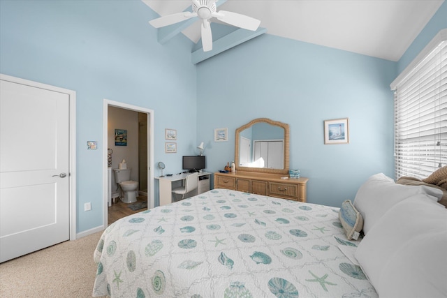 bedroom with ceiling fan, light colored carpet, connected bathroom, and high vaulted ceiling