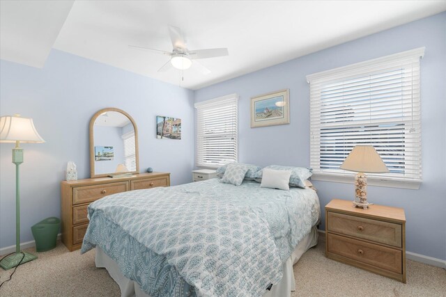 bedroom featuring ceiling fan, light colored carpet, and a closet