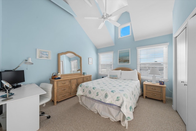 carpeted bedroom featuring ceiling fan, a closet, and high vaulted ceiling