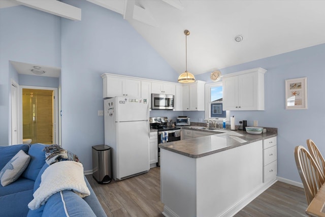 kitchen featuring decorative light fixtures, white cabinets, appliances with stainless steel finishes, and sink