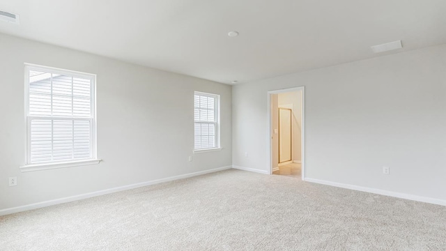 unfurnished room with light colored carpet