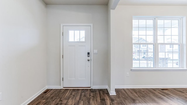 entryway with dark hardwood / wood-style flooring