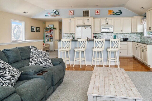 430 W Pine Ave, Wildwood, NJ 08260 - living room with lofted ceiling, light carpet, and light wood-style flooring