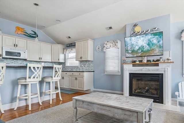 430 W Pine Ave, Wildwood, NJ 08260 - living area with vaulted ceiling, light wood-type flooring, and a premium fireplace