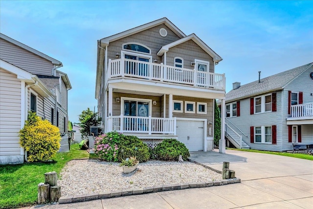 430 W Pine Ave, Wildwood, NJ 08260 - view of front of house featuring a balcony, concrete driveway, an attached garage, and covered porch
