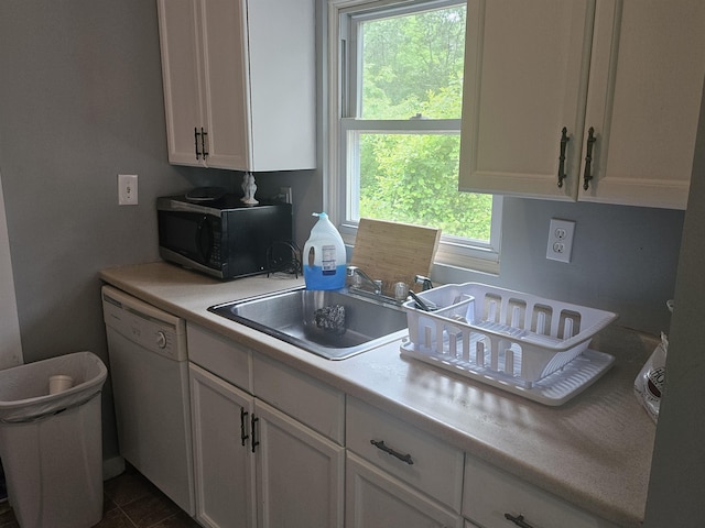 119 Hagen Rd, Clermont, NJ 08210 - kitchen featuring black microwave, white dishwasher, white cabinetry, light countertops, and a sink