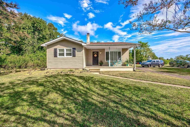 ranch-style house with a front lawn and covered porch