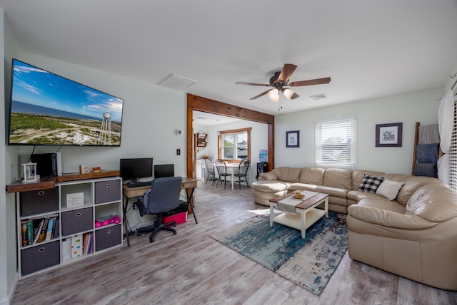 living room featuring ceiling fan and light hardwood / wood-style flooring