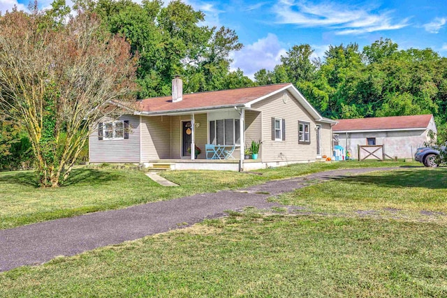 ranch-style home with covered porch and a front yard