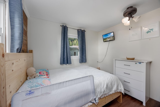 bedroom with ceiling fan and dark hardwood / wood-style flooring