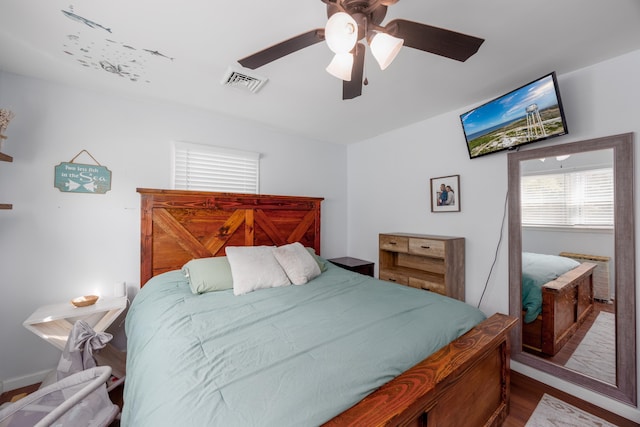 bedroom with ceiling fan and wood-type flooring