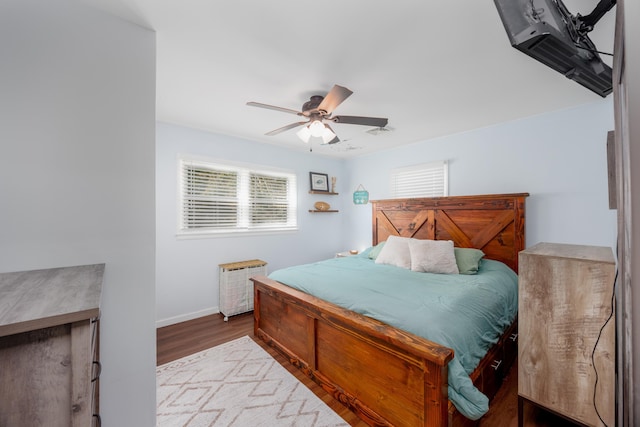 bedroom featuring multiple windows, ceiling fan, and wood-type flooring