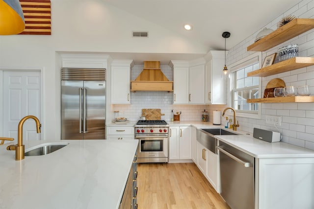 1524 Yacht Ave Unit A, Cape May, NJ 08204 - kitchen with high quality appliances, a sink, custom range hood, vaulted ceiling, and white cabinets
