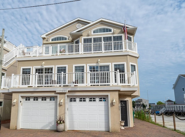 1524 Yacht Ave Unit A, Cape May, NJ 08204 - view of front facade with decorative driveway, a garage, and a balcony