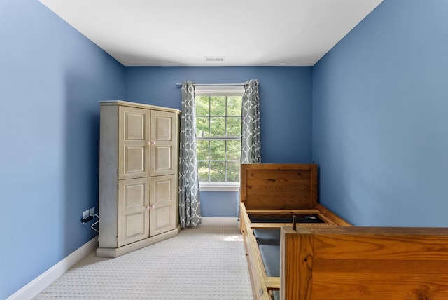 bedroom with carpet, visible vents, and baseboards